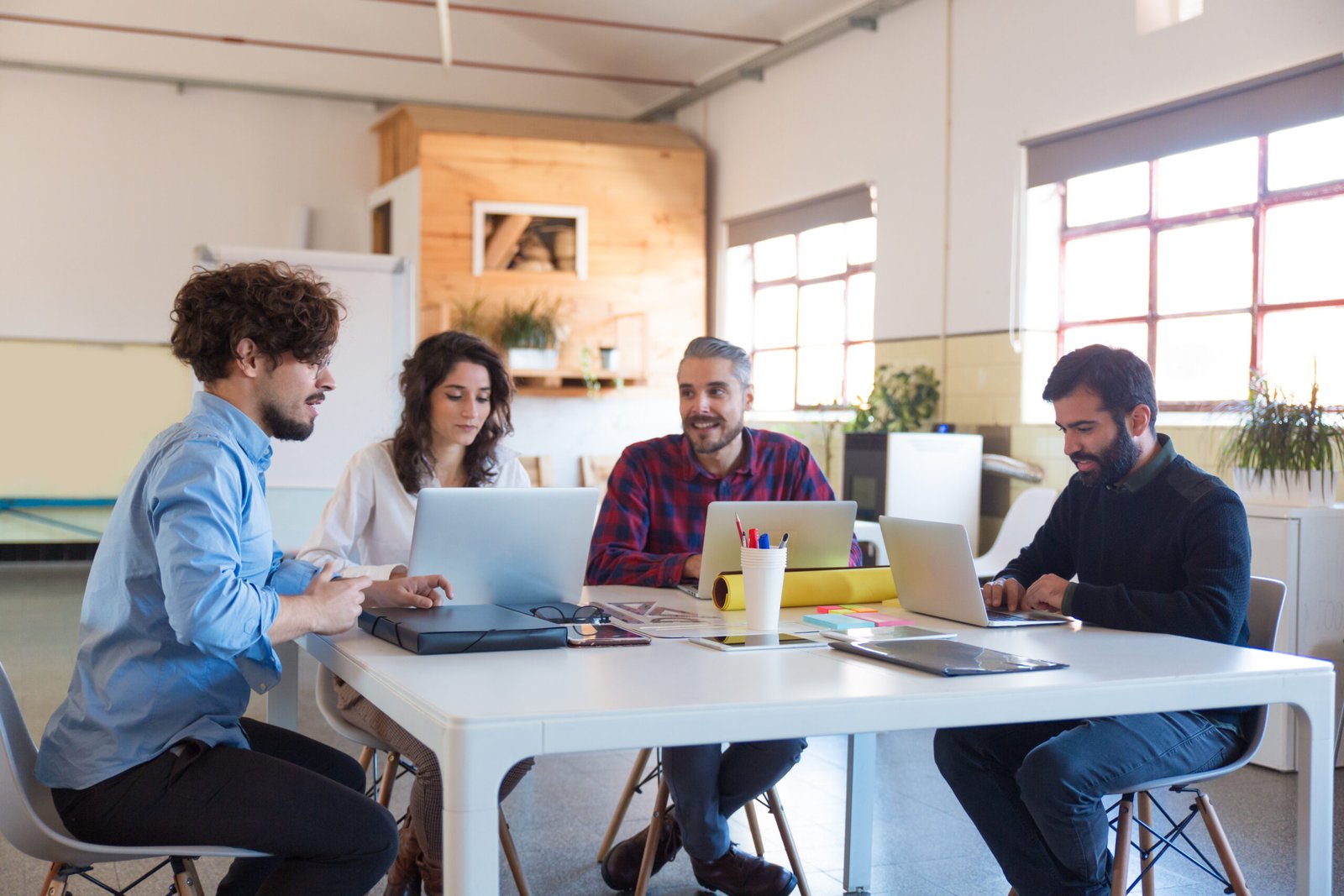 Team collaborating around a table in a modern community office